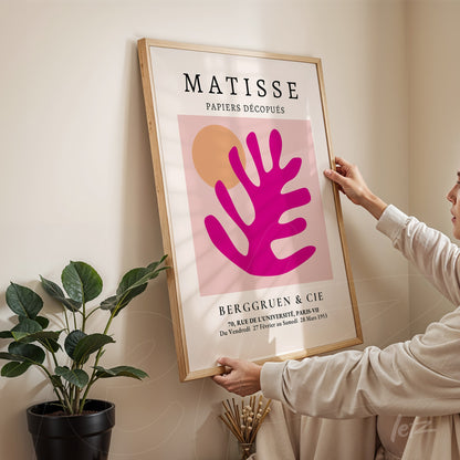 framed modern art by Matisse in light wood frame displayed on neutral wall