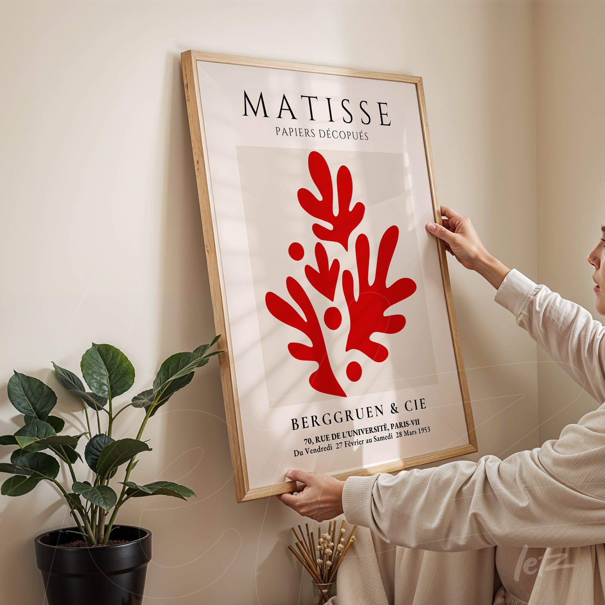 framed wall art featuring matisse design with organic red shapes on white background and light wood frame