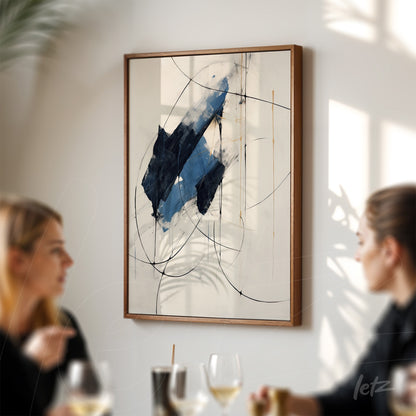 abstract wall art with dominant blue hues and curved lines in a dark wooden frame displayed on a wall with two people in the foreground