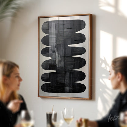 abstract artwork in wooden frame featuring black background and wavy shapes in varying textures