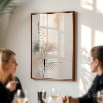 abstract wall art featuring fine lines and organic shapes in a light wood frame, hung on a wall illuminated by natural light