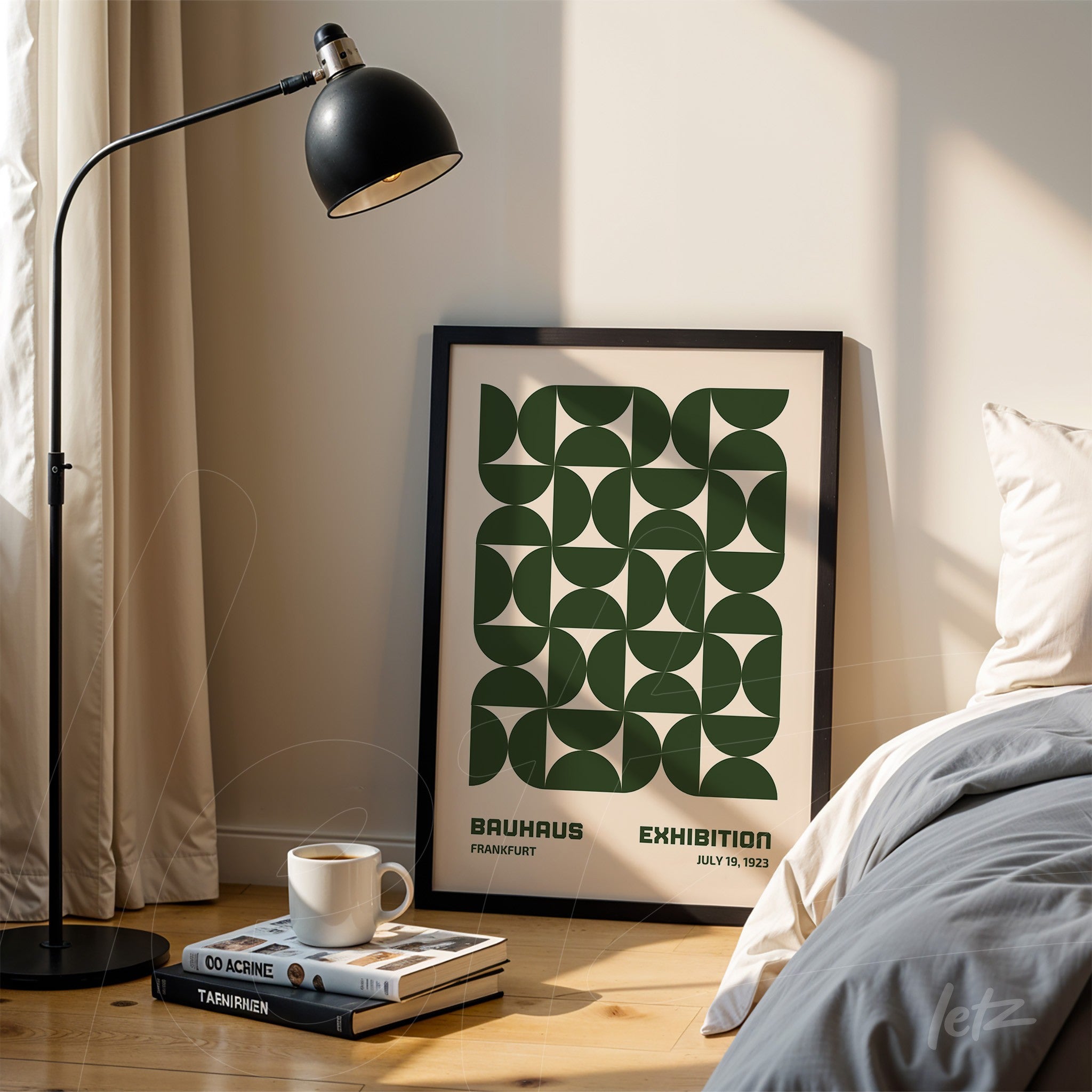 poster print featuring green geometric design in black frame leaning on the floor next to a modern lamp