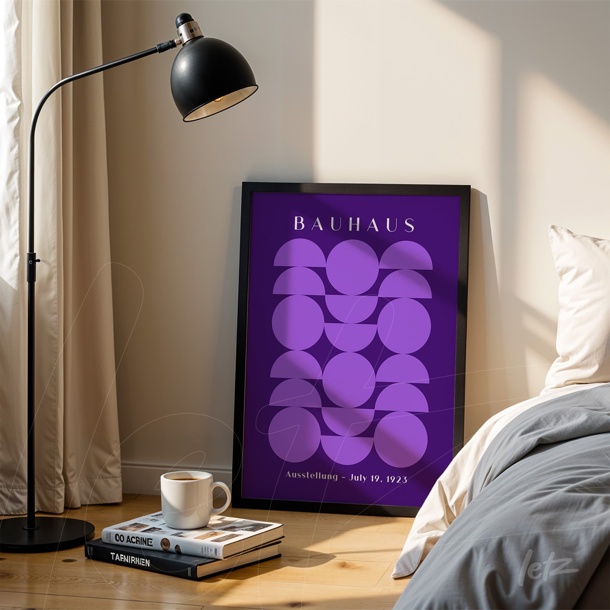 framed geometric bauhaus art poster in shades of purple resting on wooden floor next to a black lamp