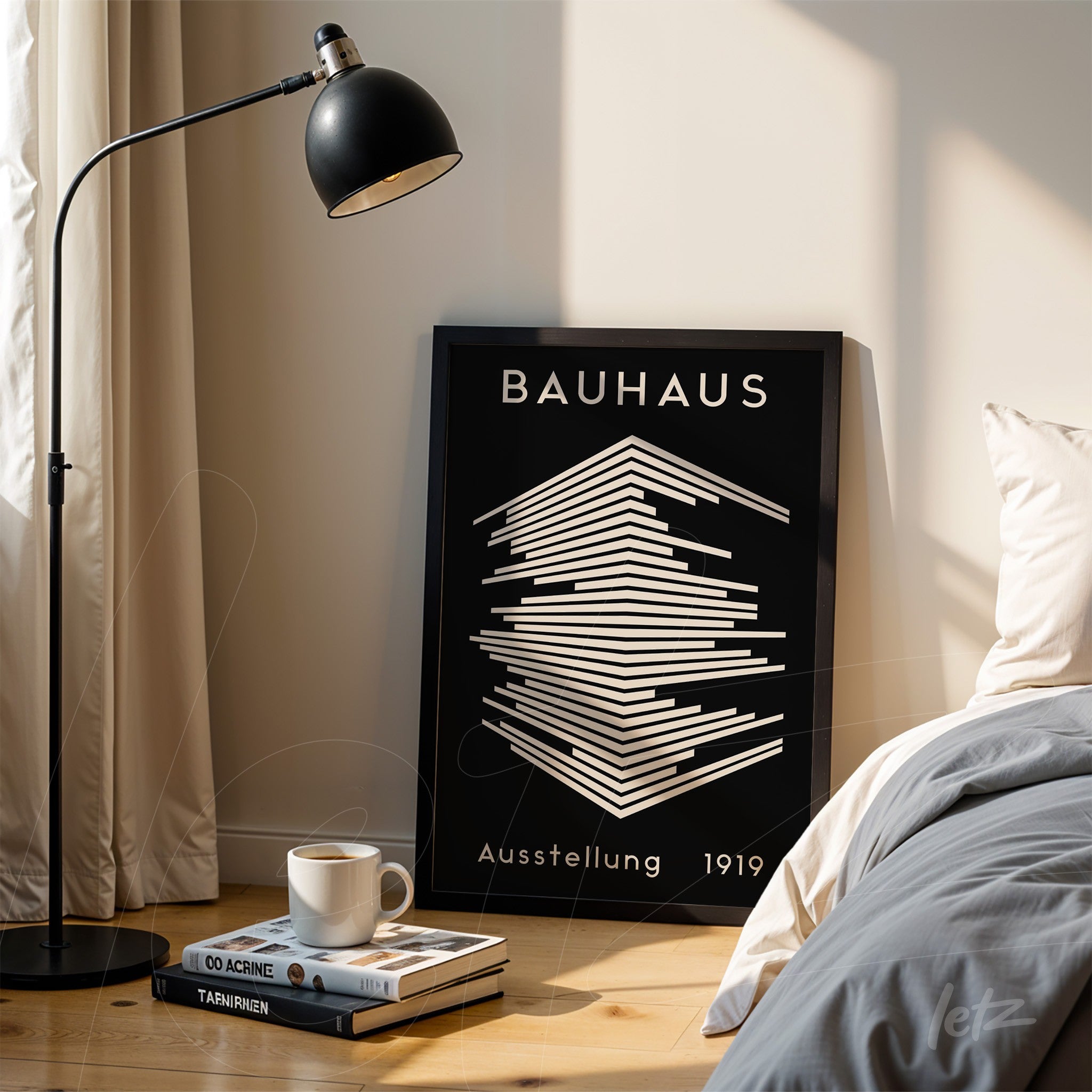 poster with geometric bauhaus style design in black frame resting on wooden floor next to bed