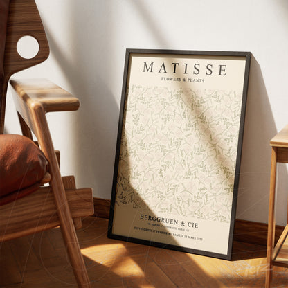 framed art inspired by Matisse featuring floral design in black frame displayed next to a wooden chair