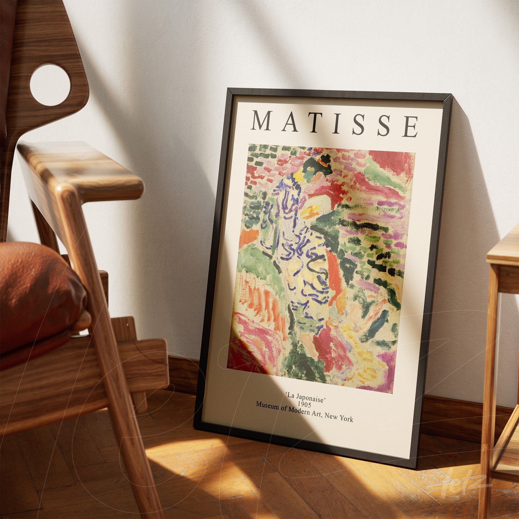 framed abstract art print by Matisse titled 'La Japonaise' leaning beside a wooden chair