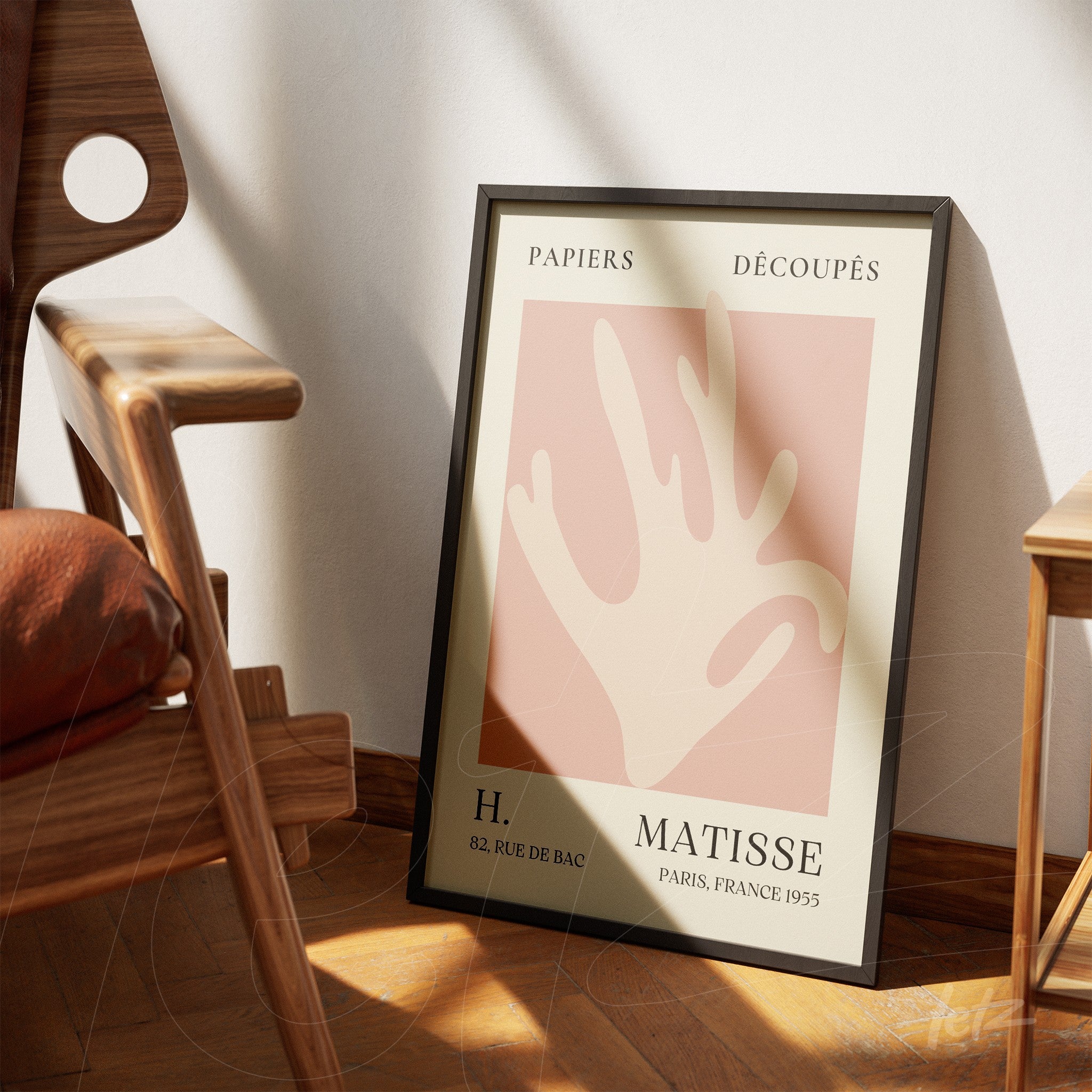 modern art print in pastel shades featuring a stylized hand with an elegant black frame leaning beside a wooden chair