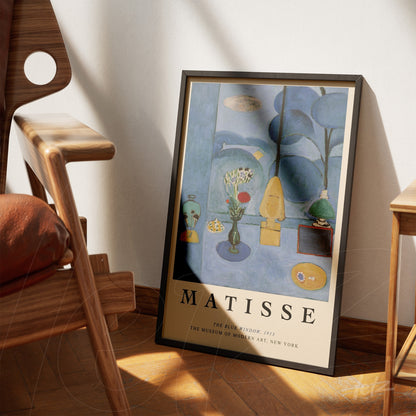 framed modern art print by Matisse featuring a blue and green composition with flowers in a vase and abstract shapes, leaning next to a wooden chair