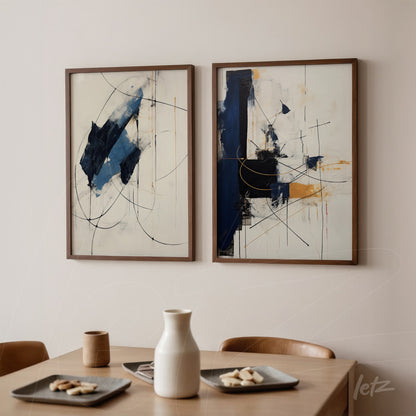 composition of two abstract wall artworks with predominant blue and touches of yellow in dark wooden frame displayed on a light wall