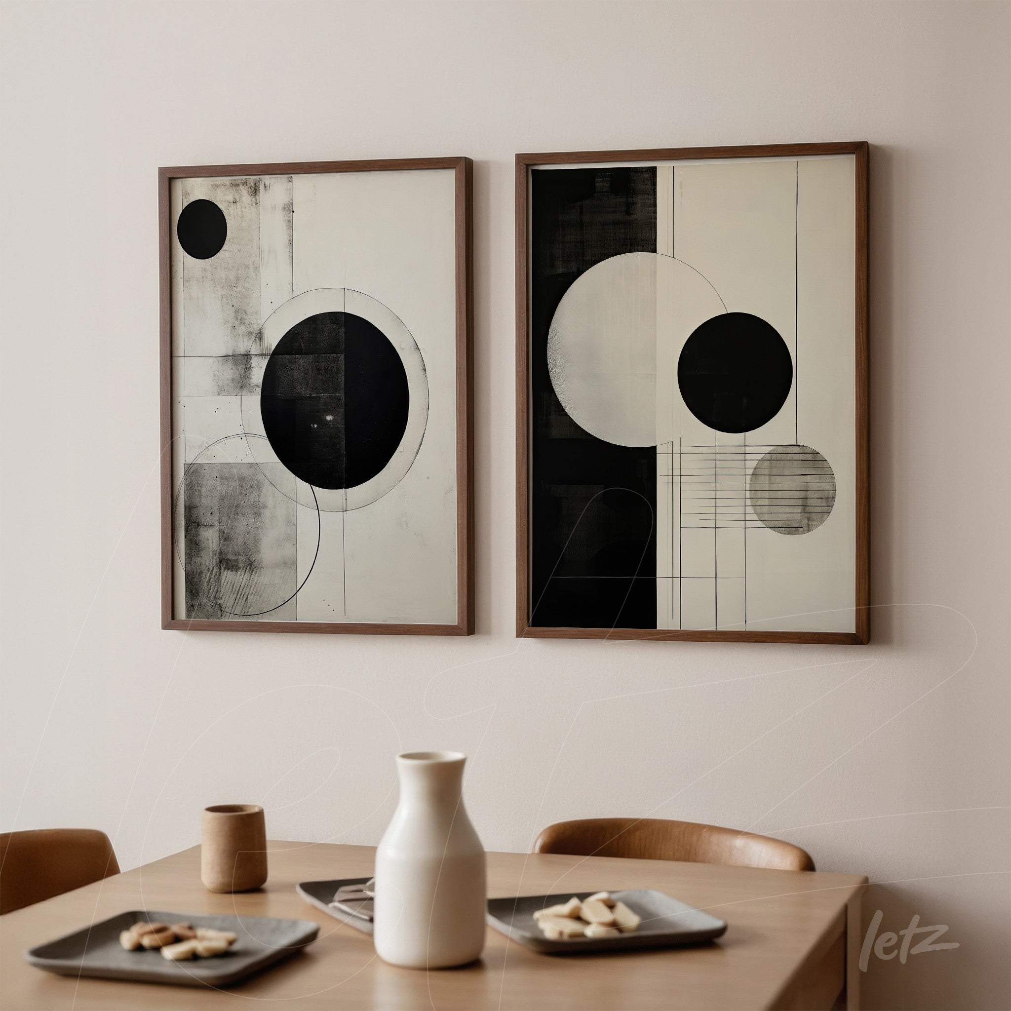 set of framed black and white abstract art pieces in light wood frames on a neutral wall