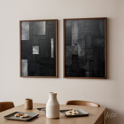 set of abstract wall art in black and gray tones with light wood frames displayed on a neutral wall