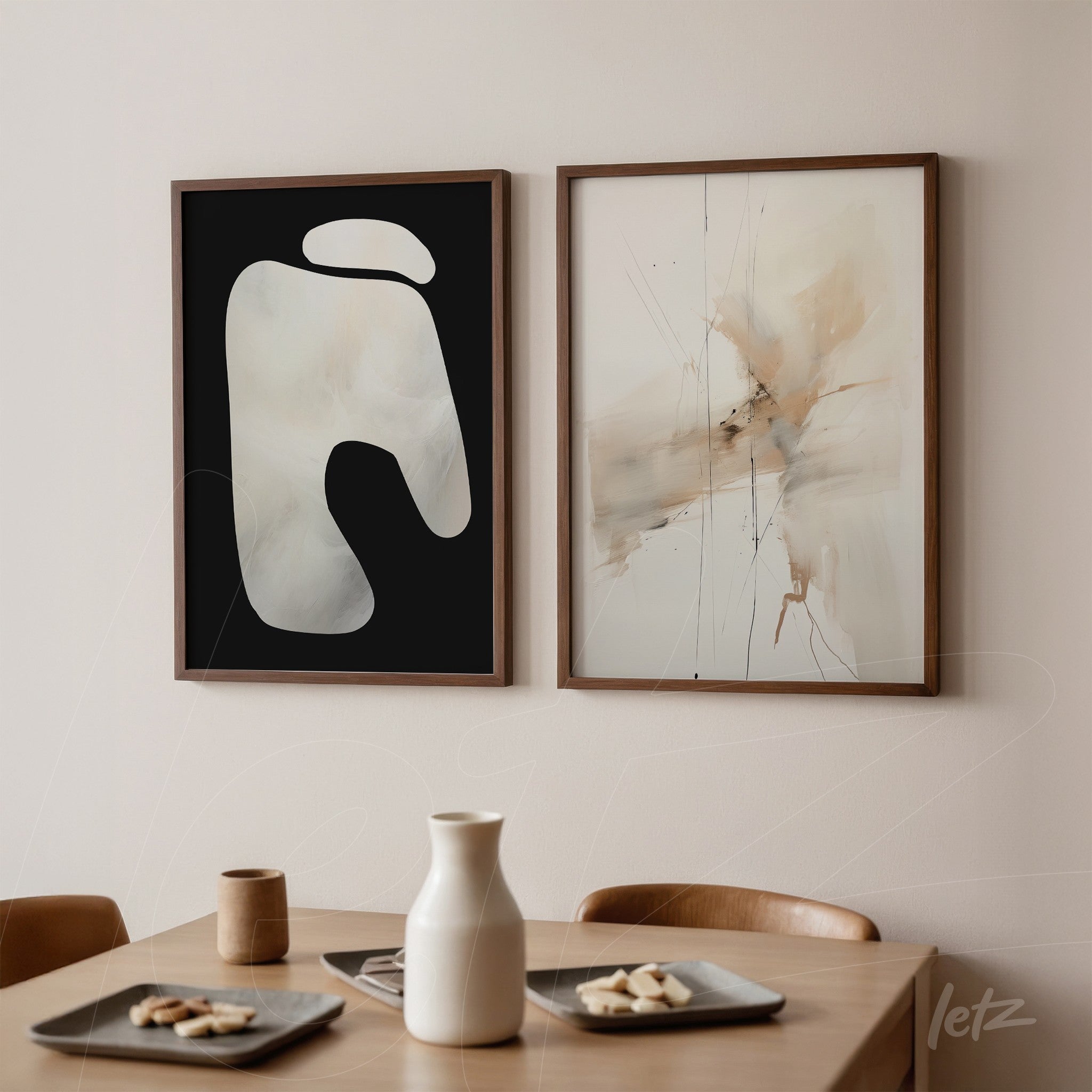framed wall art composition featuring abstract designs with one piece showcasing fluid white shapes on black background and the other displaying earthy tones with fine lines on light backdrop