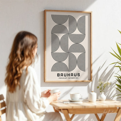 bauhaus geometric art poster print in a light wood frame against a white wall