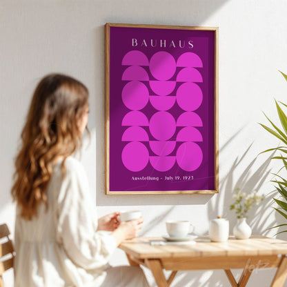 poster print featuring geometric design in shades of purple with light wood frame displayed on white wall