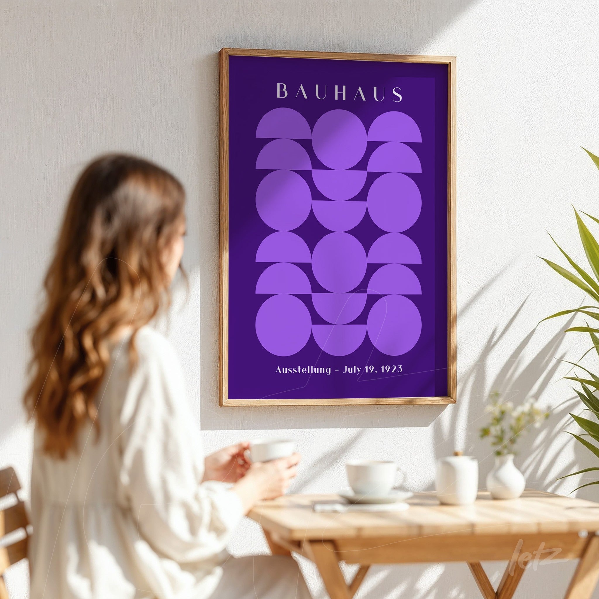 modern bauhaus style art with purple geometric shapes displayed in a light wood frame