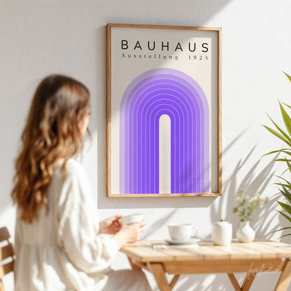 bauhaus style poster with purple geometric arches, displayed in a light wood frame on a white wall