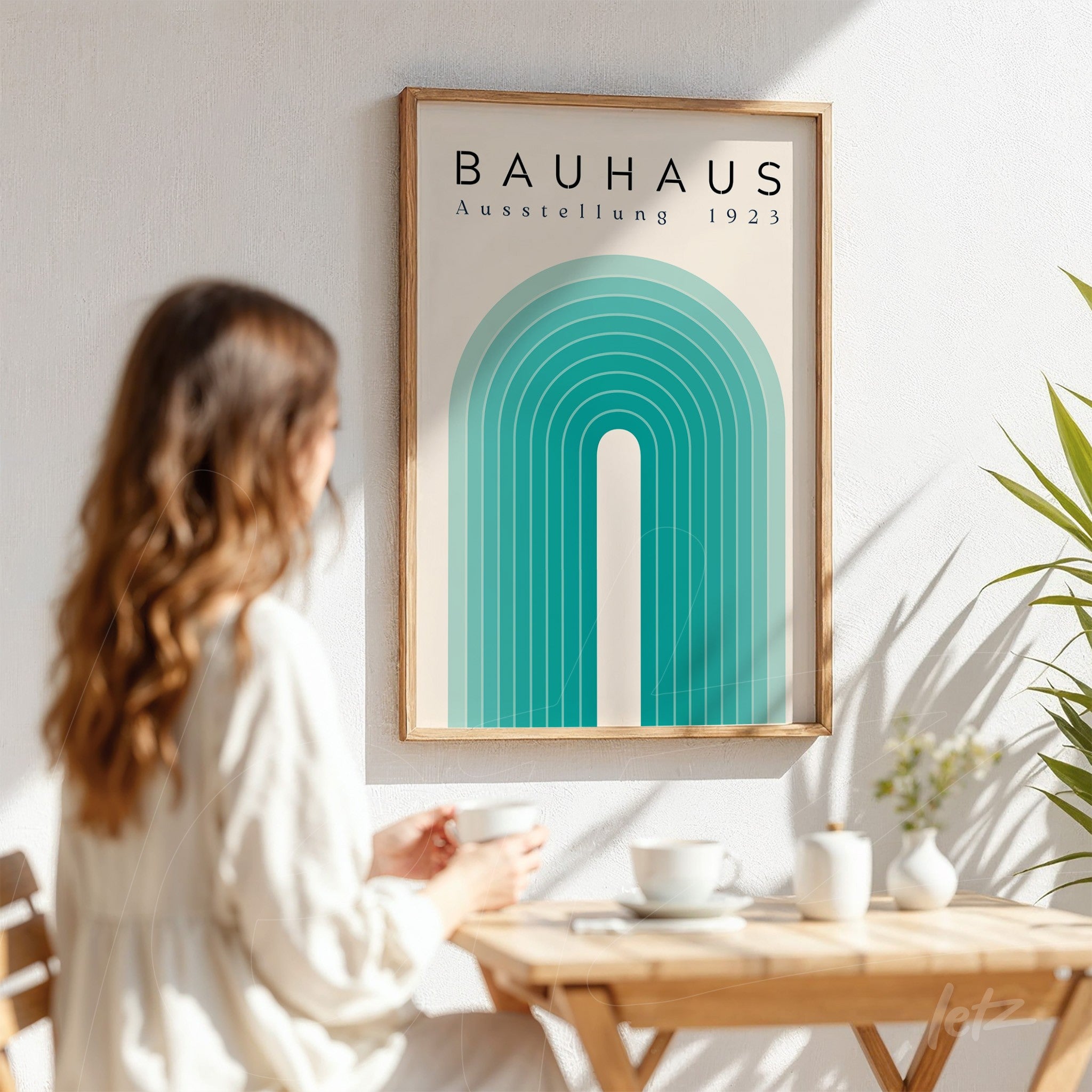 poster print of green geometric arch in bauhaus style with light frame, displayed on white wall next to a coffee table