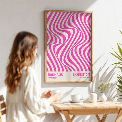 poster with pink and white geometric design in light wood frame displayed on a white wall