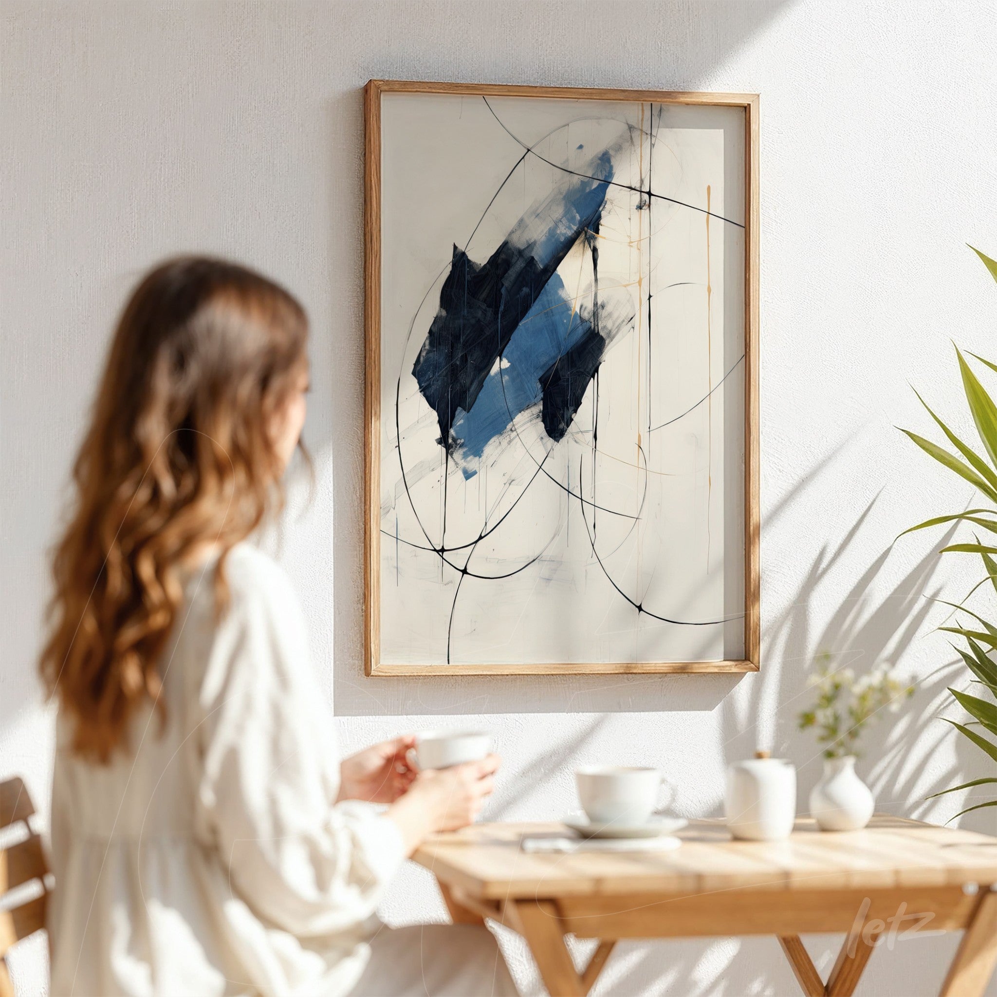 abstract wall art in light wood frame displayed in a well-lit setting, featuring blue and white brush strokes