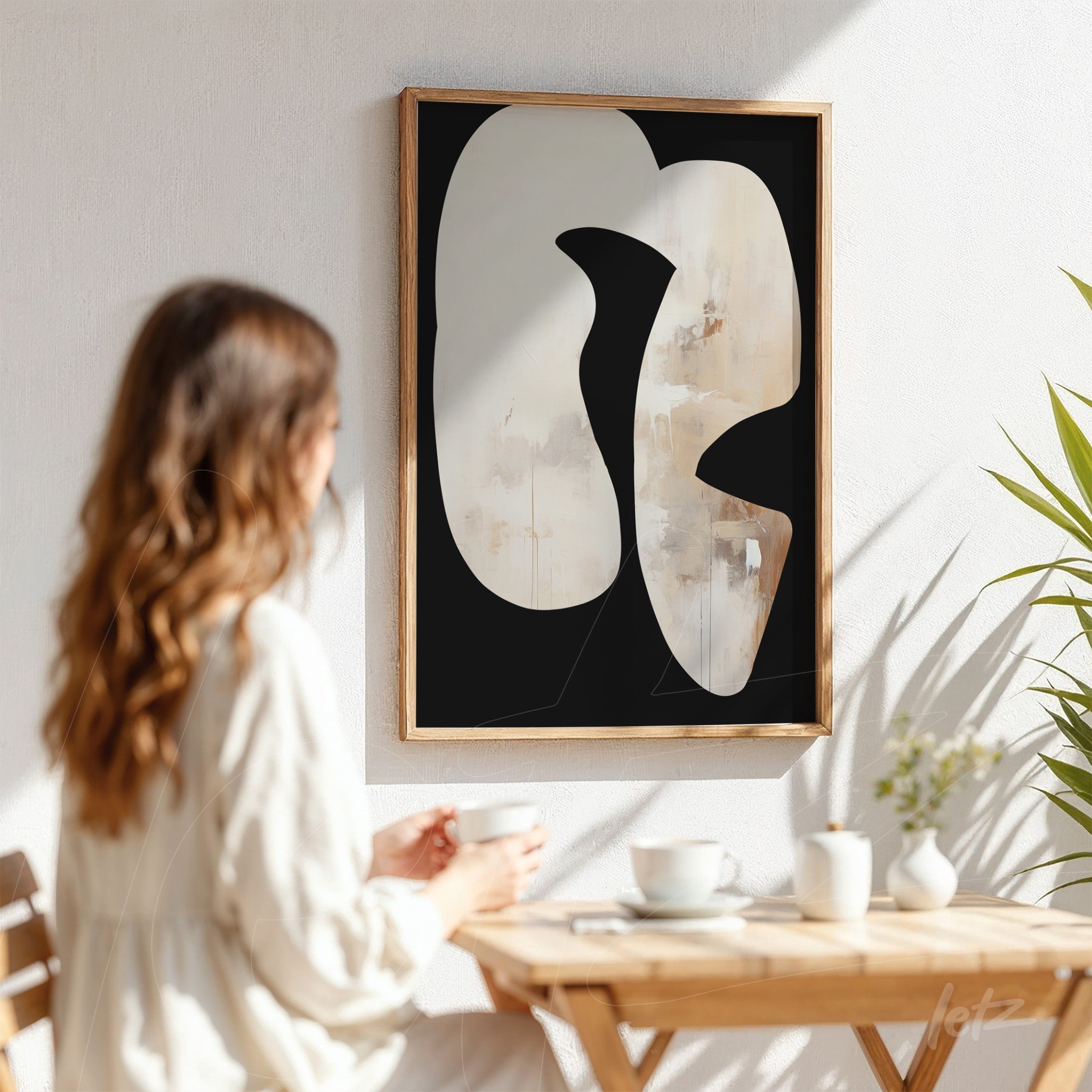 abstract art framed print in light wood frame displayed in a bright setting with black background