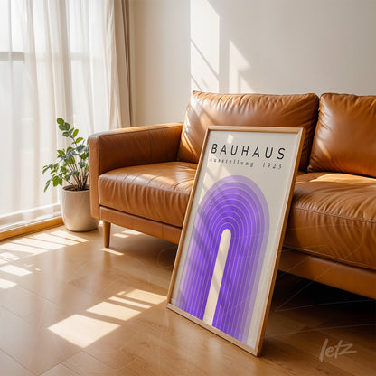 poster print featuring bauhaus geometric art in light frame leaning against leather sofa