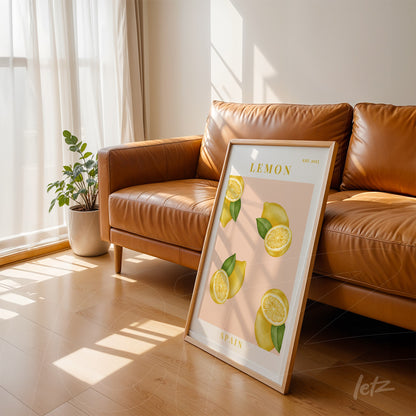 framed art of sliced lemons with white frame leaning against brown leather sofa