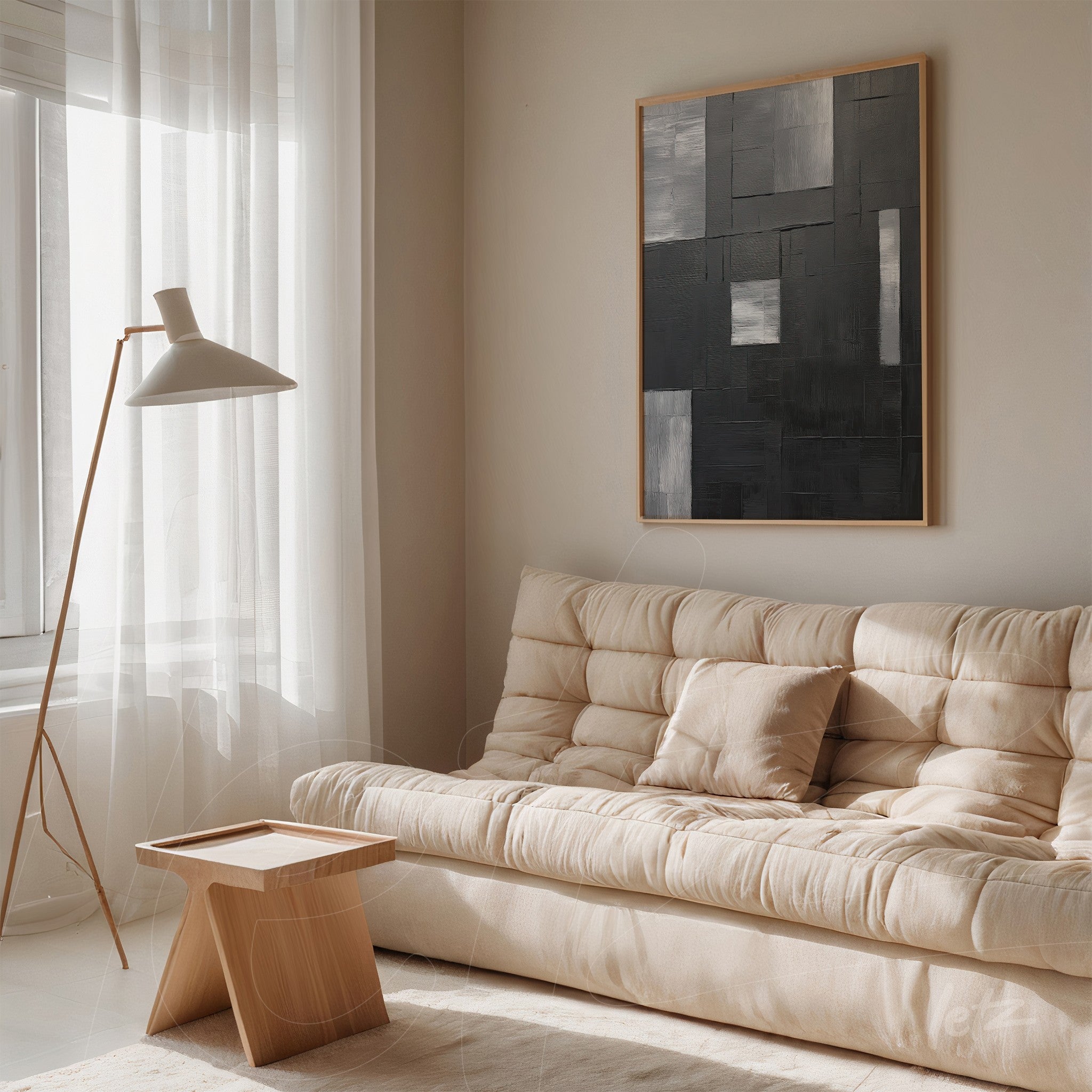 abstract wall art in shades of gray with light frame above beige sofa in minimalist interior