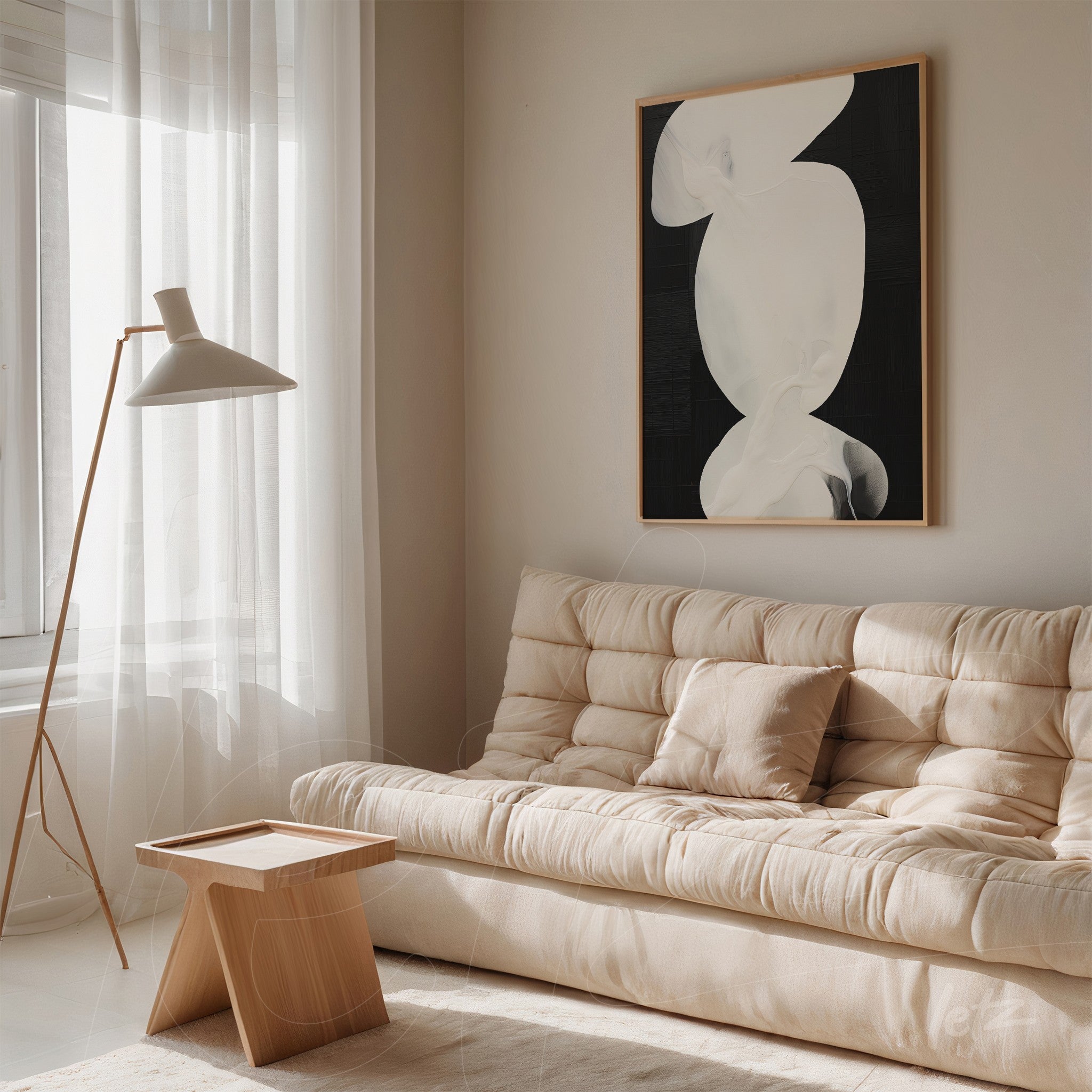 abstract art piece with black background in light wood frame displayed in living room featuring beige sofa and standing lamp
