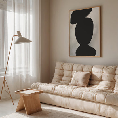 abstract wall art in light frame displayed above sofa in a well-lit room