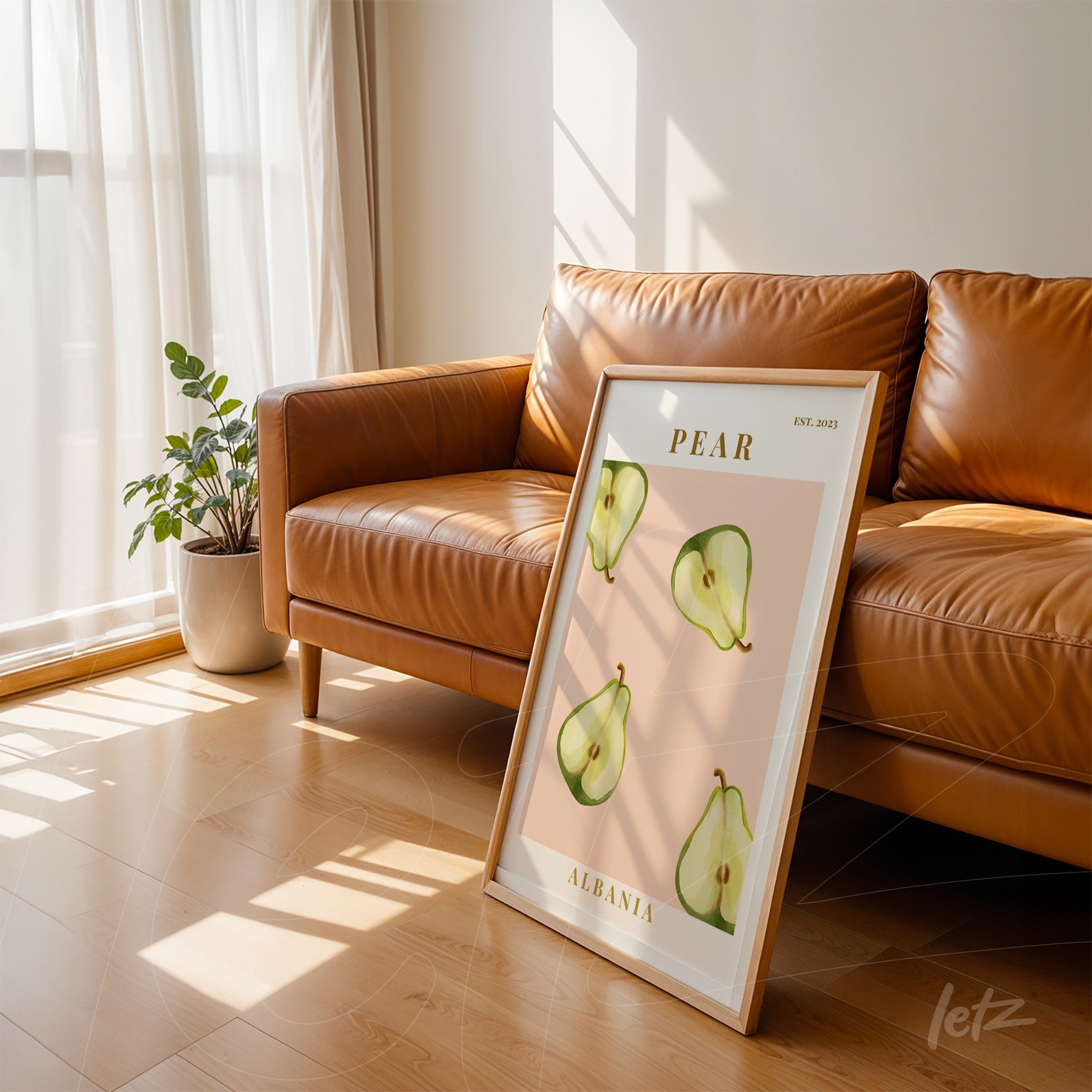 framed wall art featuring pear illustration on light pink background with white frame leaning against brown sofa