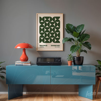 framed poster with green geometric design displayed above a blue sideboard in a modern room