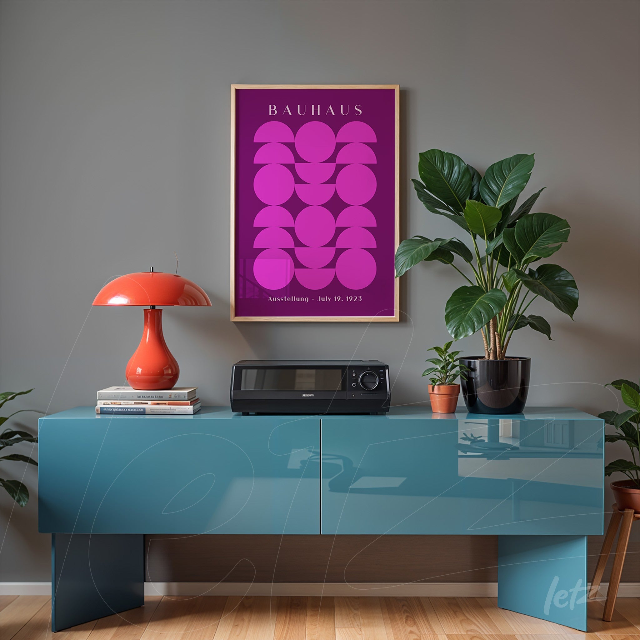 framed poster with purple geometric Bauhaus design displayed on grey wall above blue sideboard with orange lamp and plant