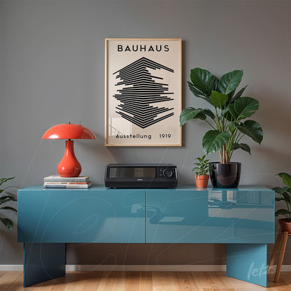 poster featuring bauhaus style illustration of black and white geometric shapes in light wood frame against a gray wall