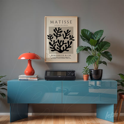 framed art print by Matisse displayed above a modern blue cabinet with decorative elements