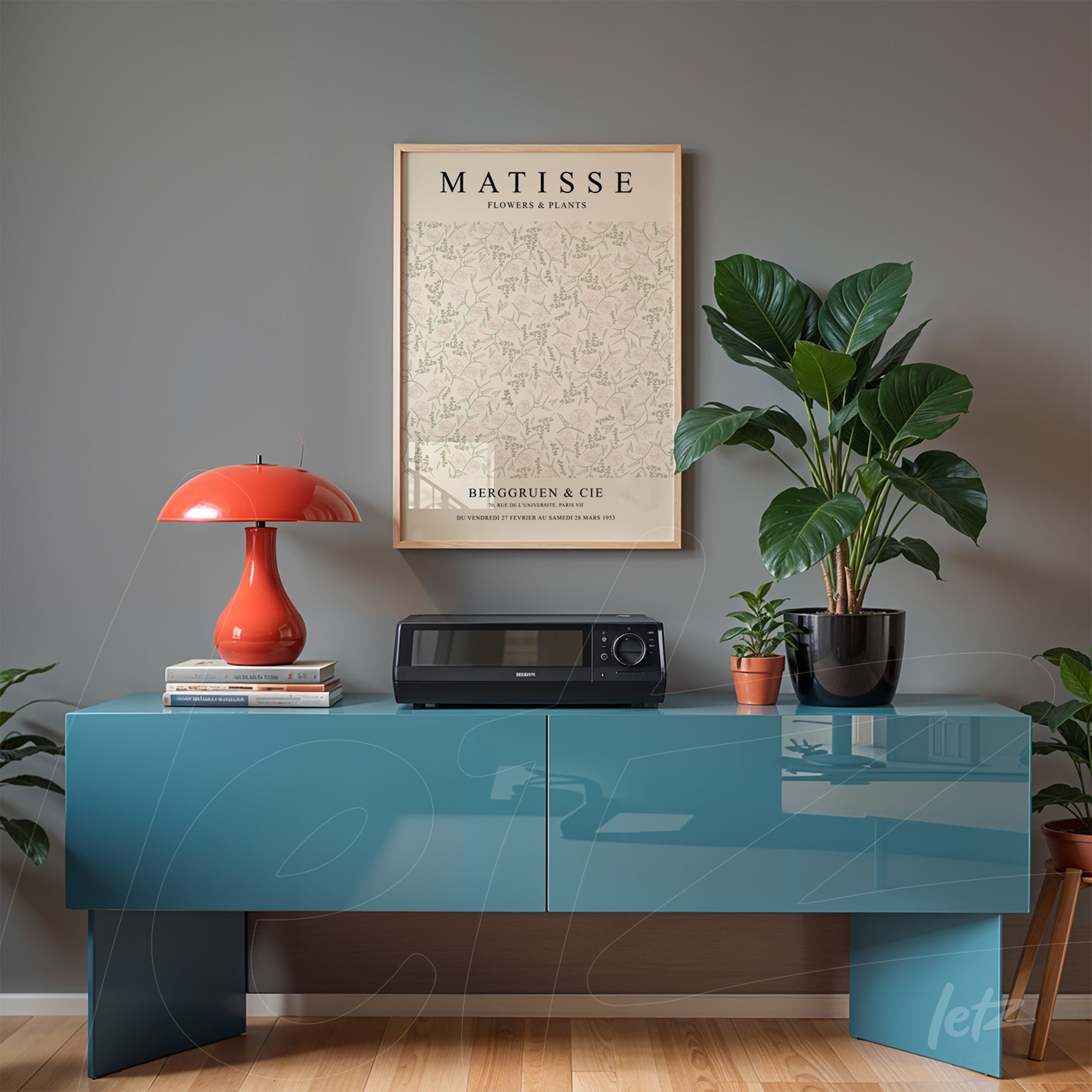framed botanical art by matisse displayed above a blue cabinet with a plant beside it