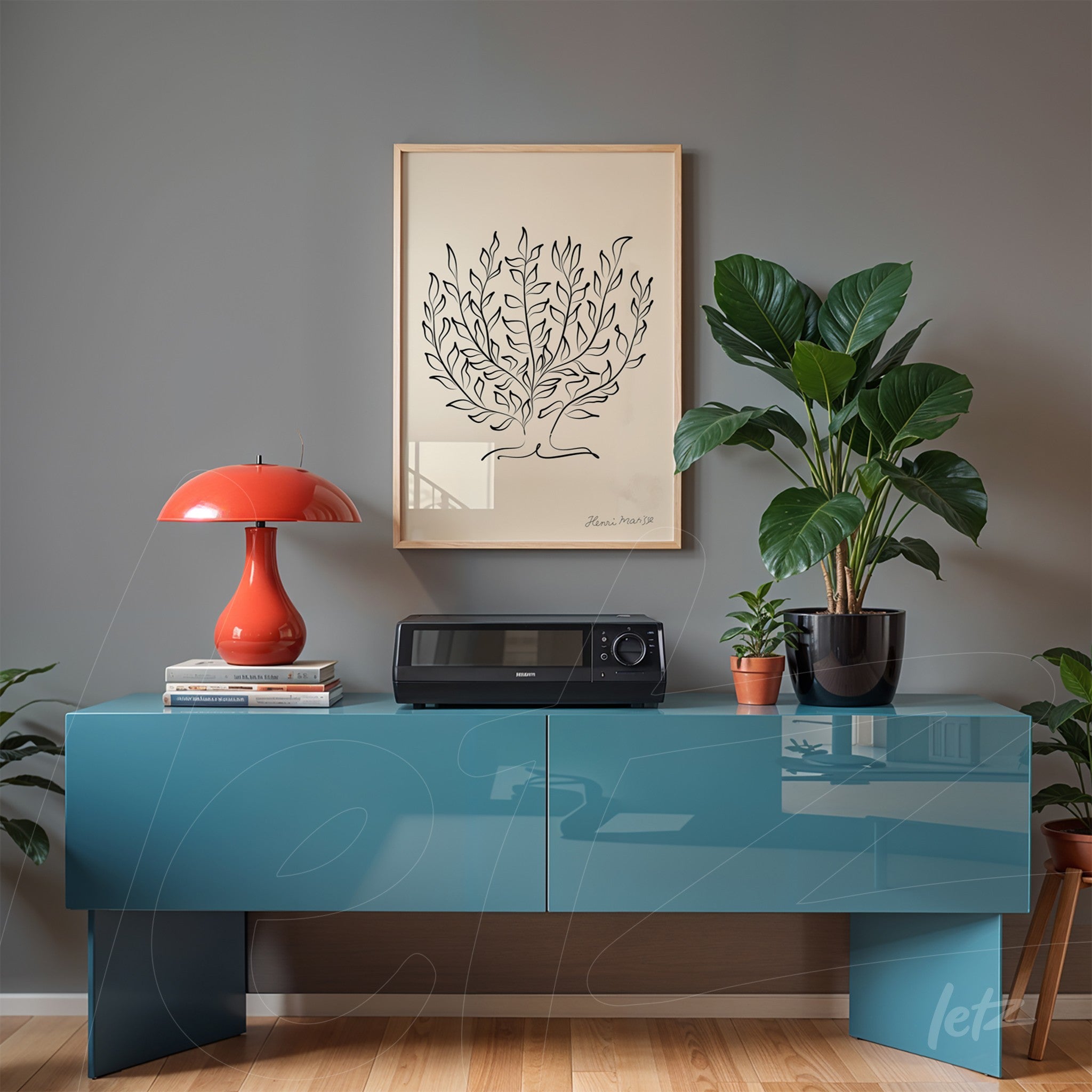 minimalist framed artwork of a palm tree displayed above a blue cabinet with a red lamp and indoor plants