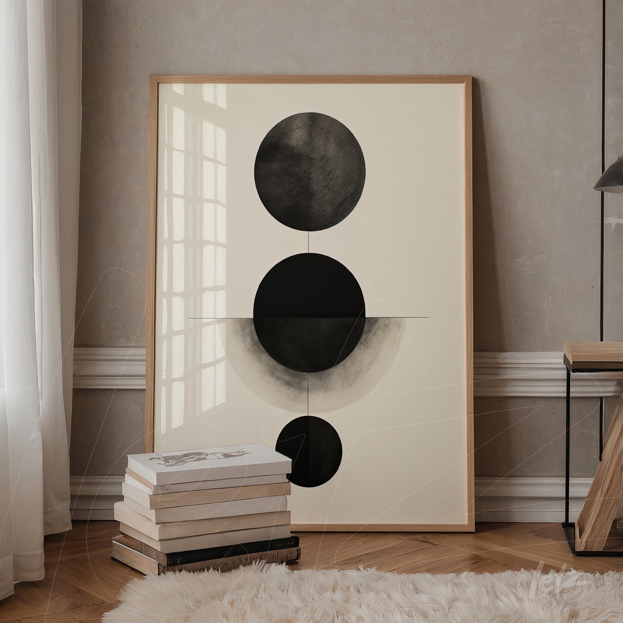 abstract wall art featuring black circles on a light background, framed in light wood, displayed against a beige wall