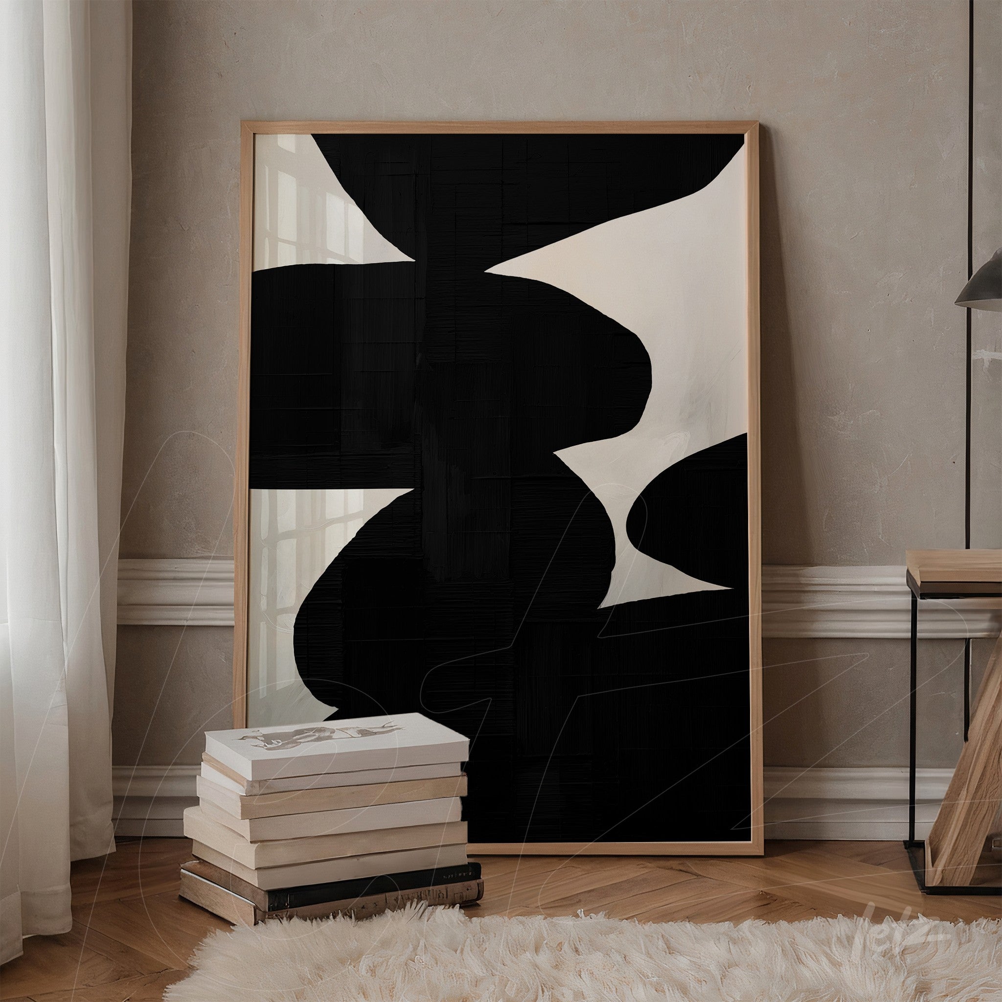 modern wall art in light wood frame featuring abstract black and white shapes on textured background