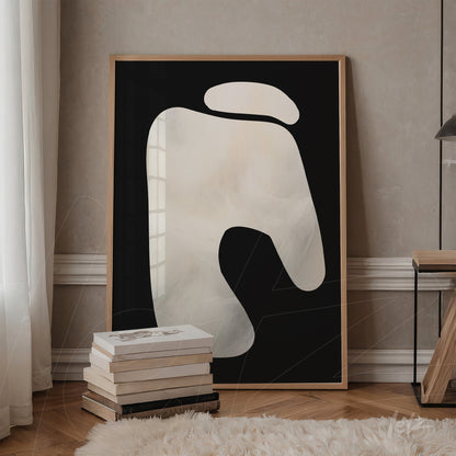 abstract wall art in light wood frame featuring soft white shapes on a black background