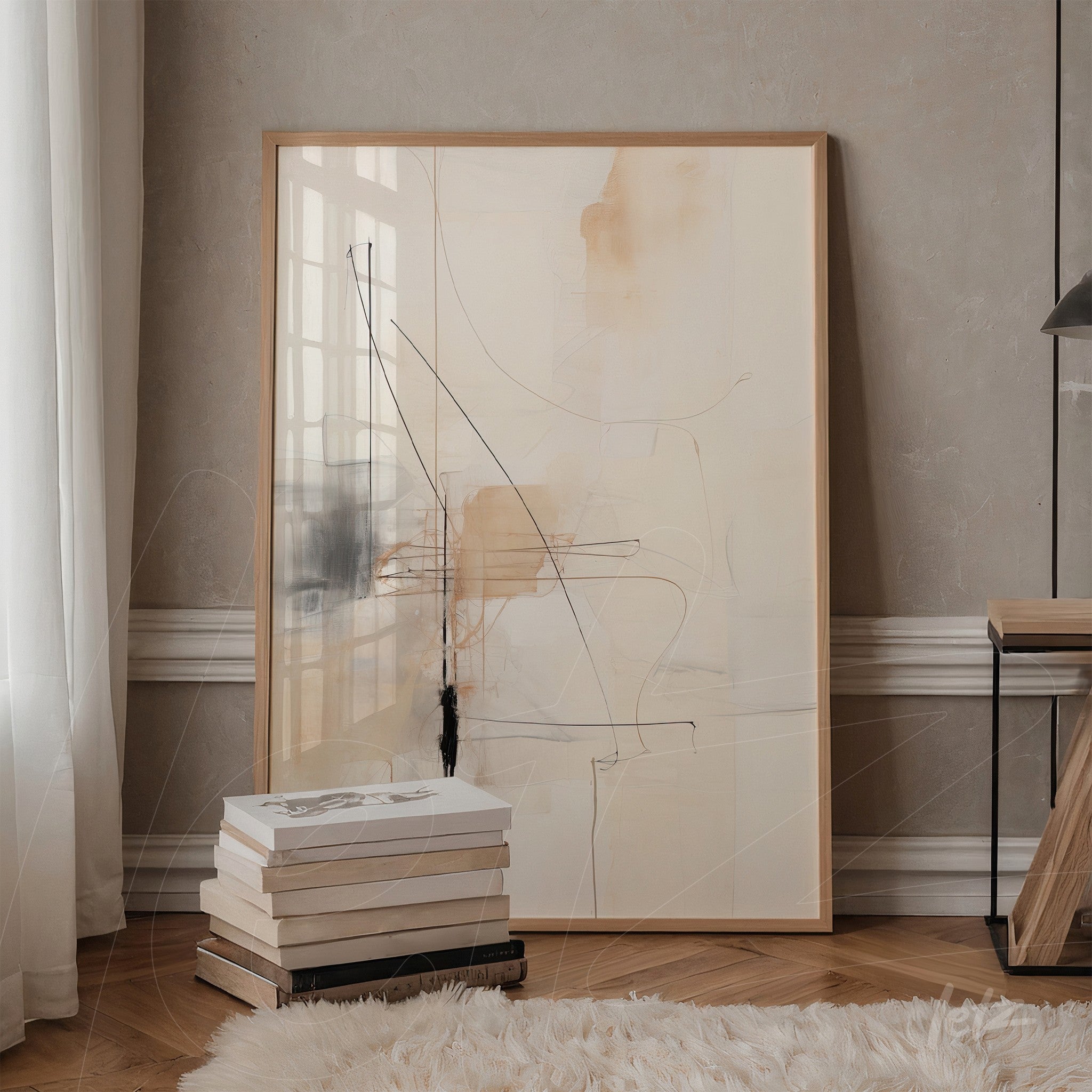 abstract artwork with lines in shades of beige and black in a light wood frame, leaning against a textured wall
