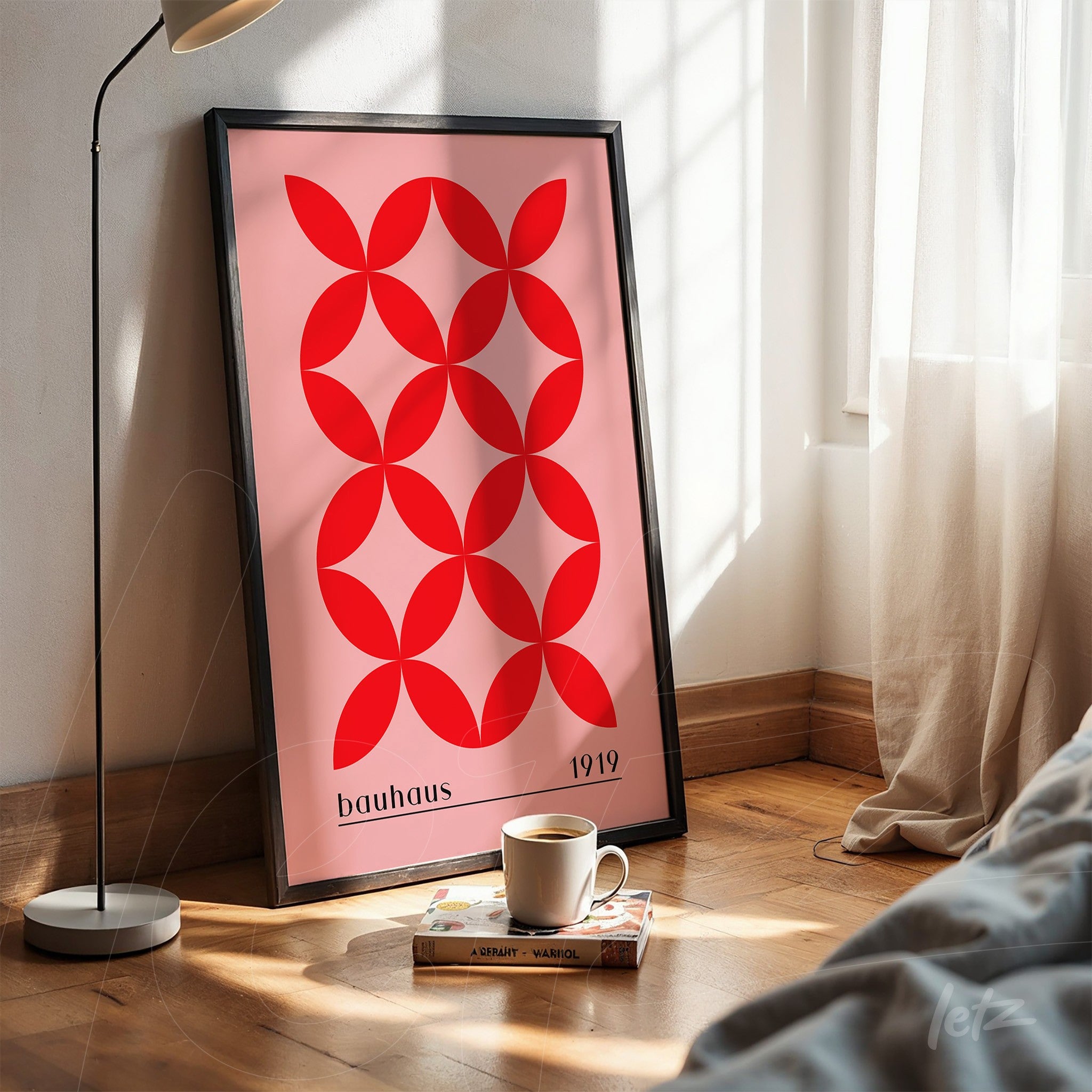 poster print featuring geometric bauhaus style design in black frame resting on wooden floor