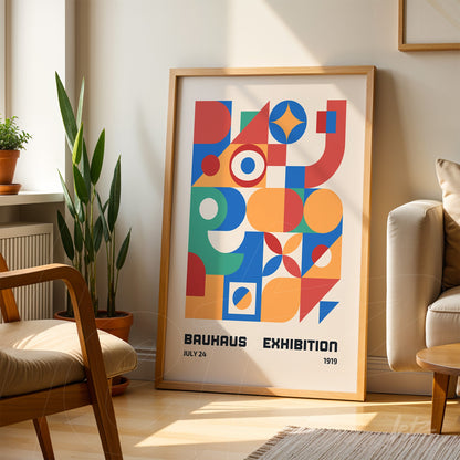 poster with colorful geometric lines and shapes in light wooden frame leaning against a wall in a naturally lit living room