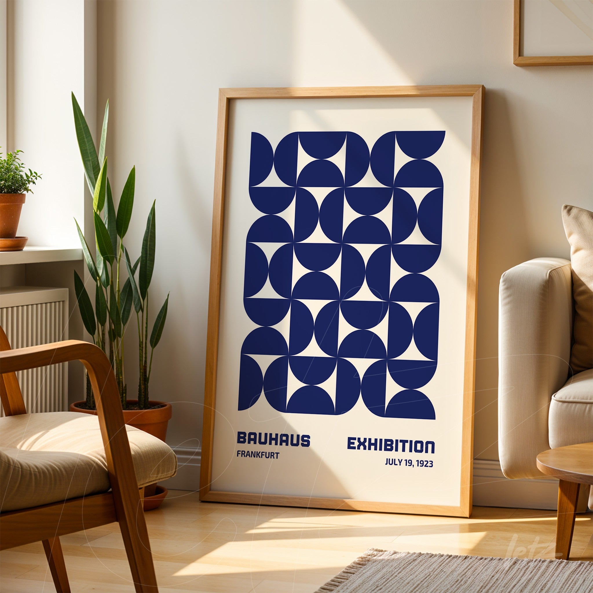 poster print of geometric Bauhaus style art with light wood frame, displayed on a rug in a sunlit room