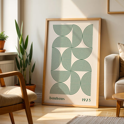 geometric spiral Bauhaus style poster in light wood frame resting on sunlit living room floor