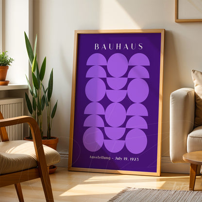 poster print with geometric purple art, light wooden frame resting on the floor beside living room furniture
