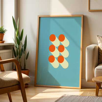 poster featuring abstract art of orange circles on a light blue background framed in light wood, placed in a well-lit room