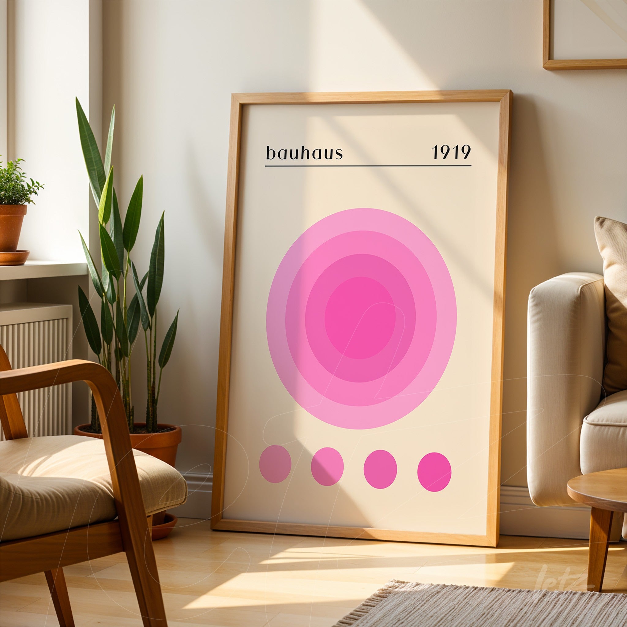 decorative poster with pink circles in Bauhaus style, set in a light wooden frame, displayed in a well-lit room