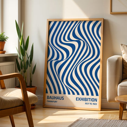 poster with wavy geometric blue and white illustration in light wood frame, leaning in a bright room