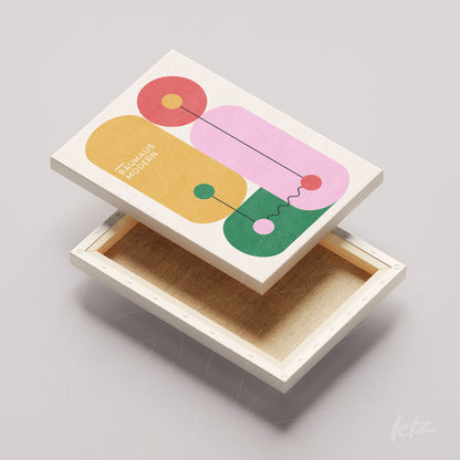 image of a canvas print with modern abstract art in pink, yellow, and green tones partially folded over a wooden box
