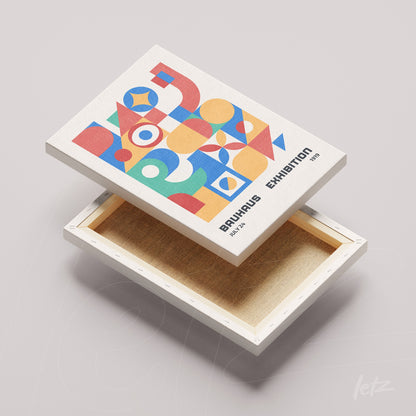 canvas print featuring colorful geometric Bauhaus design, displayed in natural wood frame